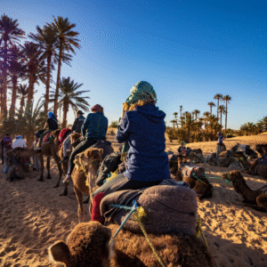 tourist riding camel on desert, Morocco desert tours