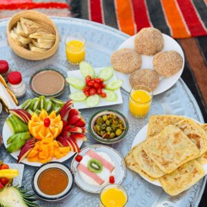 Post-flight celebration in a Berber tent with a traditional breakfast spread and flight certificates being handed out.